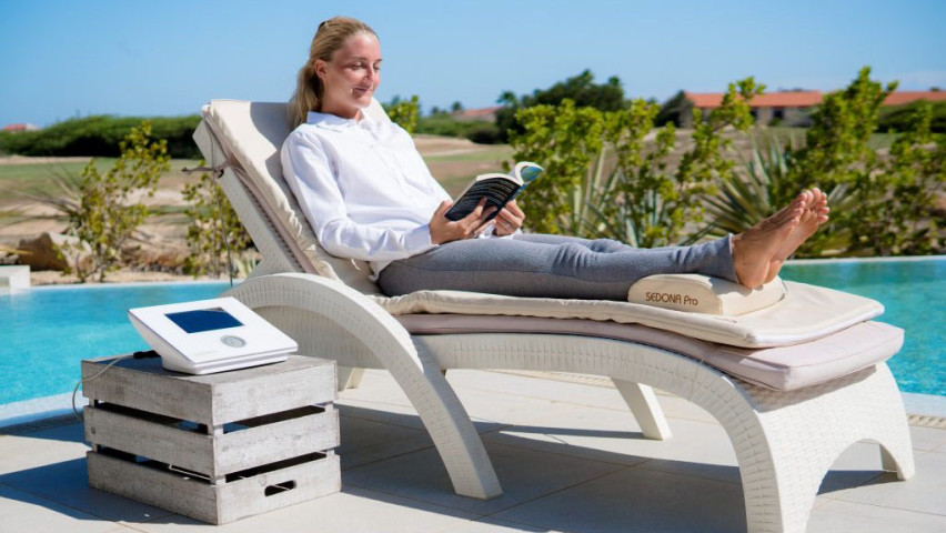 Woman using PEMF full body mat