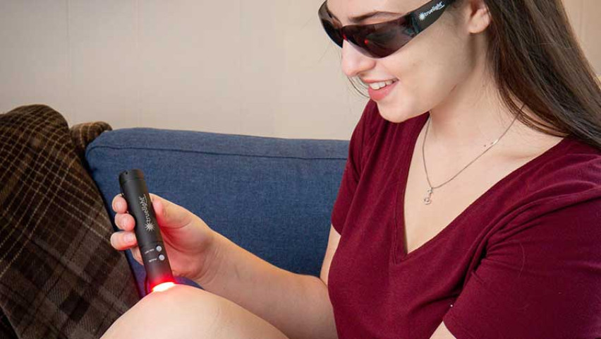 Women using truelight baton for knee